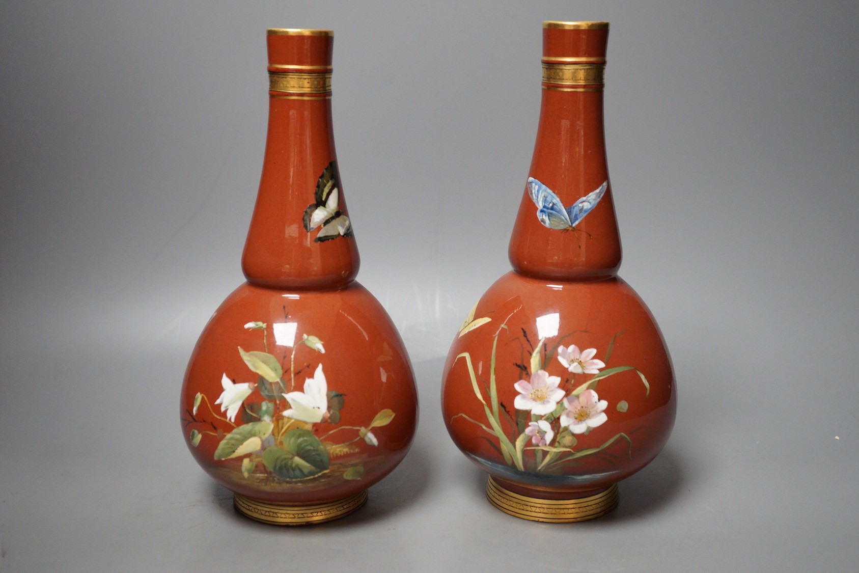 A pair of Mintons Aesthetic period enamelled pottery vases, c.1879, 26cm